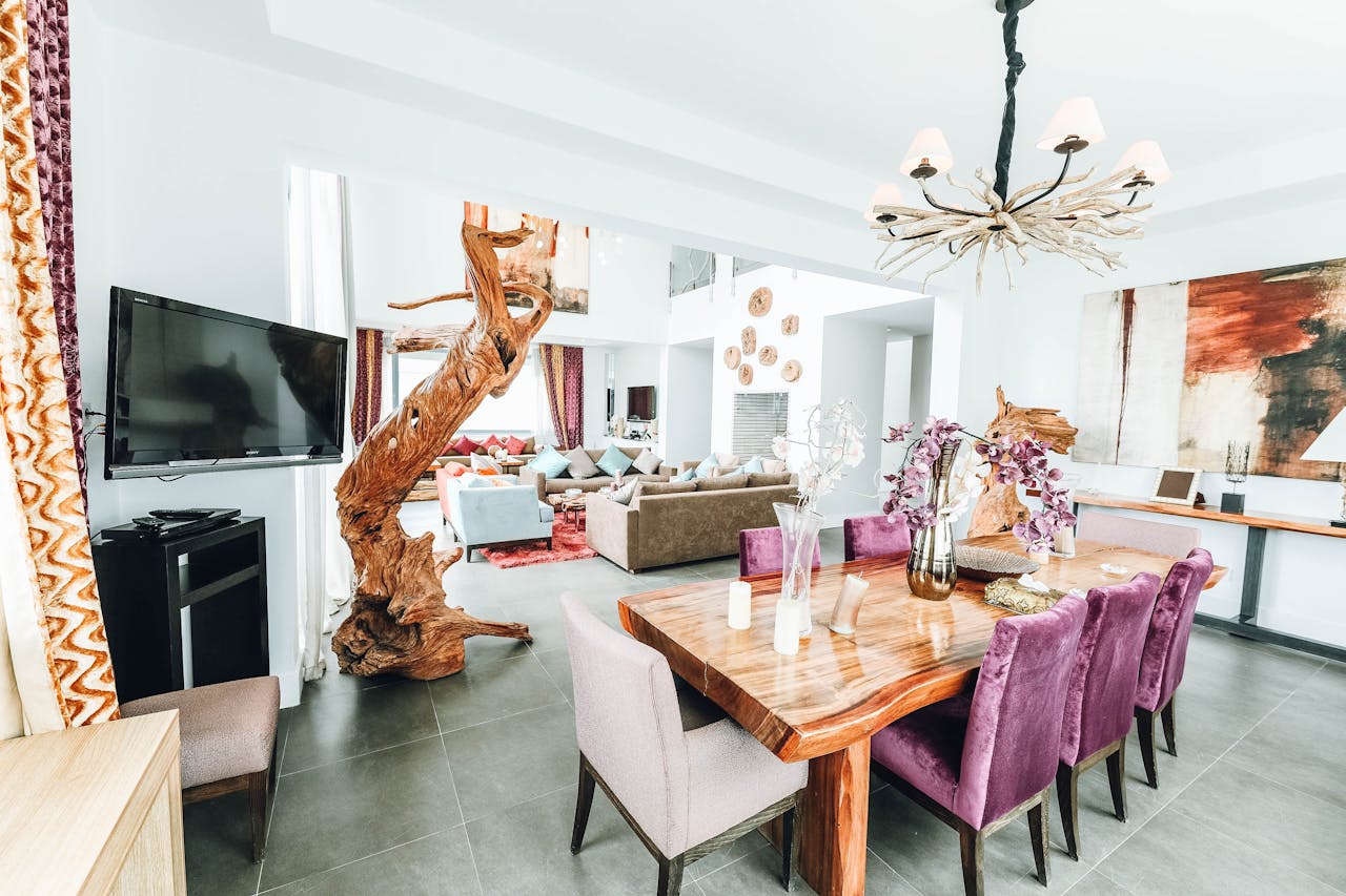 Stylish indoor dining room featuring modern decor with chandelier and artistic elements.