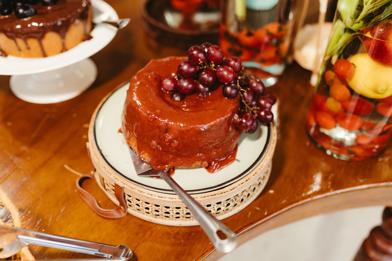 Mouthwatering cake topped with grapes, perfect for dessert lovers.